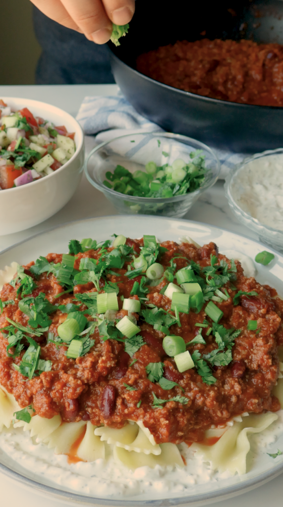 To serve, add a layer of the yogurt mix on the bottom of your plate, followed by your noodles, more yogurt and your hearty meat sauce. 
 Garnish with fresh cilantro and green onions. 